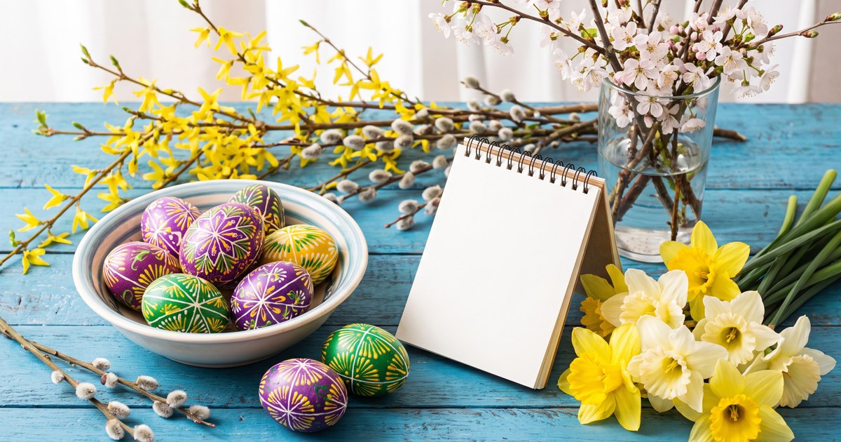 Painted Easter eggs and spring flowers in a woven basket