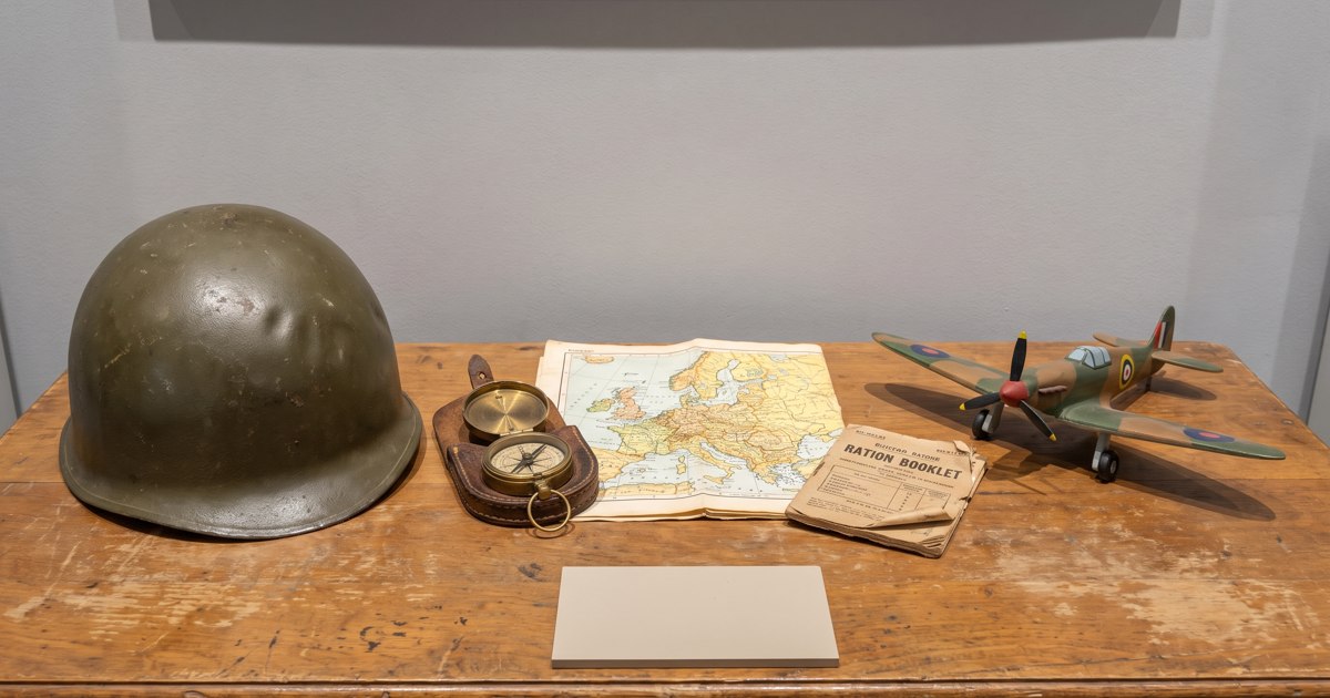 An illustrated historical world map with period aircraft and a calendar